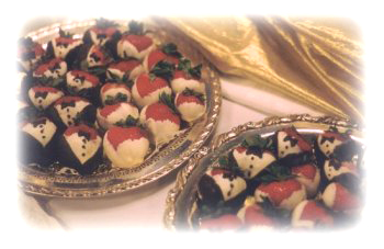 Wedding buffet. Bride and Groom tuxedoed strawberries